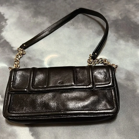 Sleek black faux leather Banana Republic purse with gold accents. - Picture 3 of 4